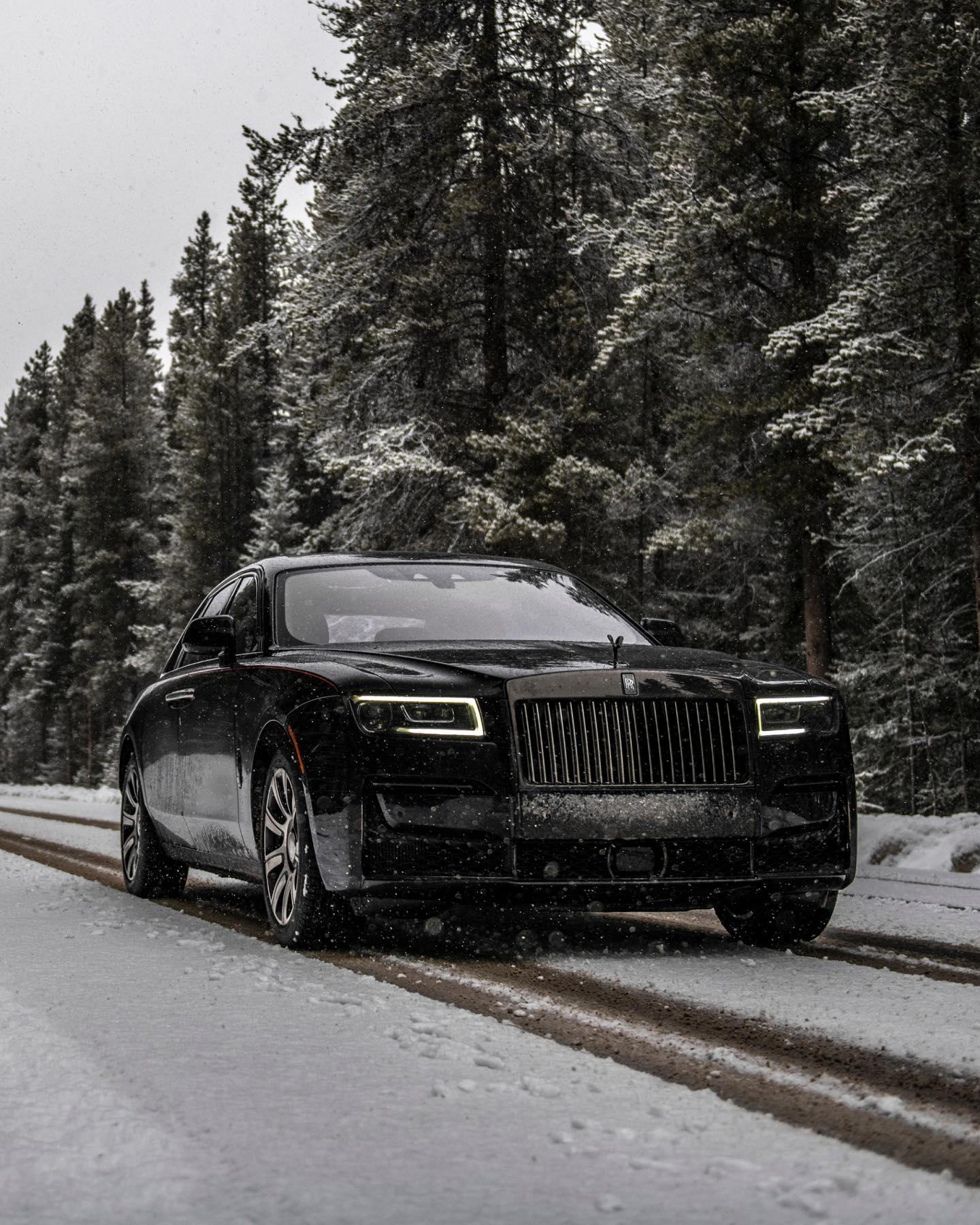 image  1 Rolls-Royce Motor Cars - Upon snow-covered grounds, Black Badge Ghost has an amplified, rebellious p