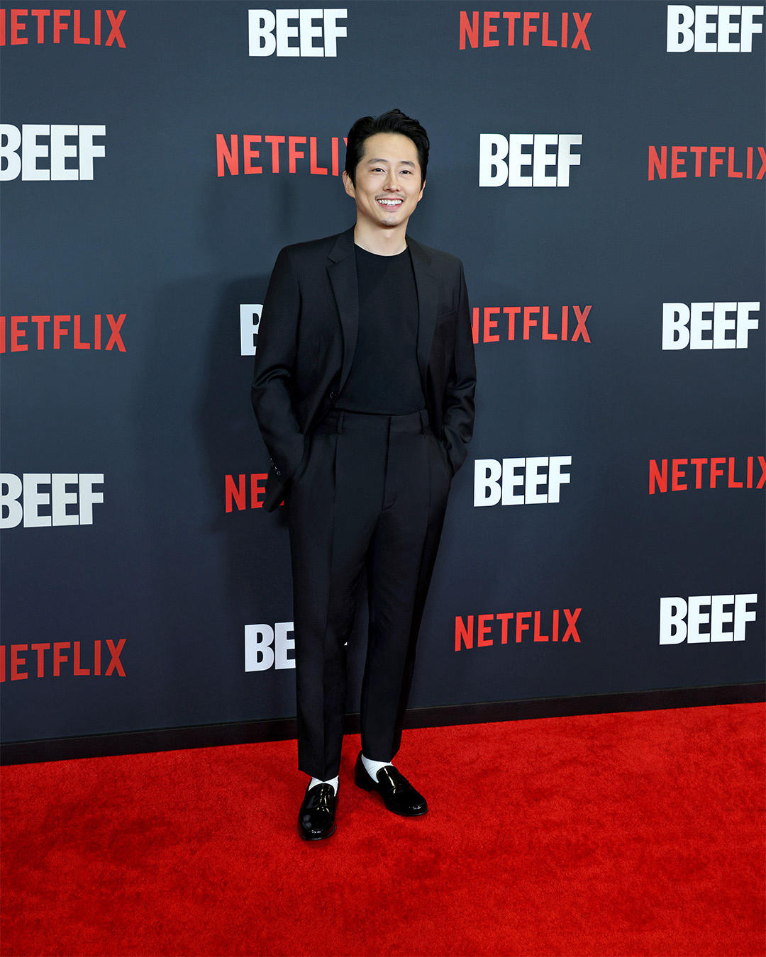 Steven Yeun wore a #Prada black single breasted wool and mohair suit, black stretch cotton t-shirt,